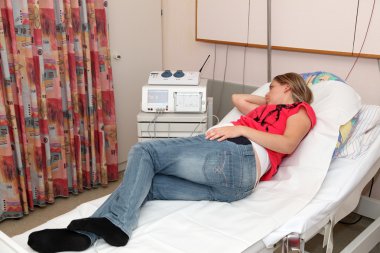 Pregnant woman in the delivery room clipart