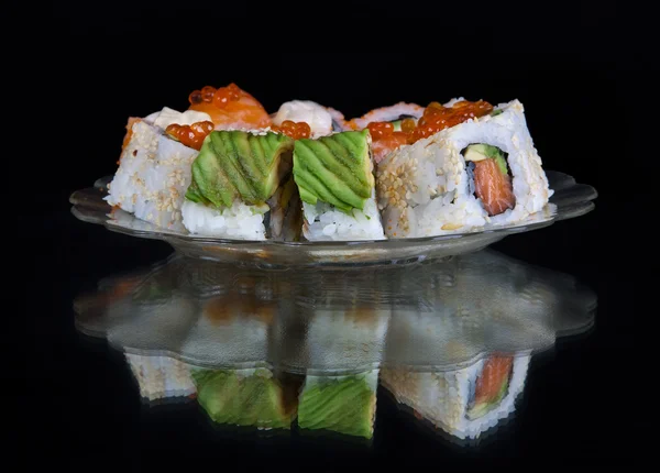 Sushi set at plate isolated on black — Stock Photo, Image