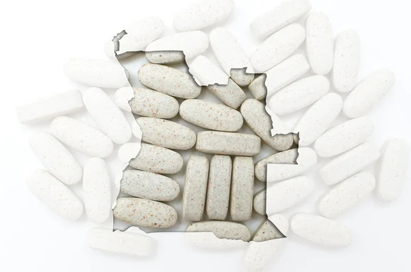 Tablettákat, a háttérben a egészségügyi szerkezeti angola Térkép egy — Stock Fotó