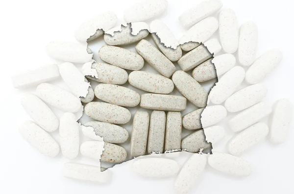 Outline map of cote'd ivore with pills in the background for hea — Stock Photo, Image