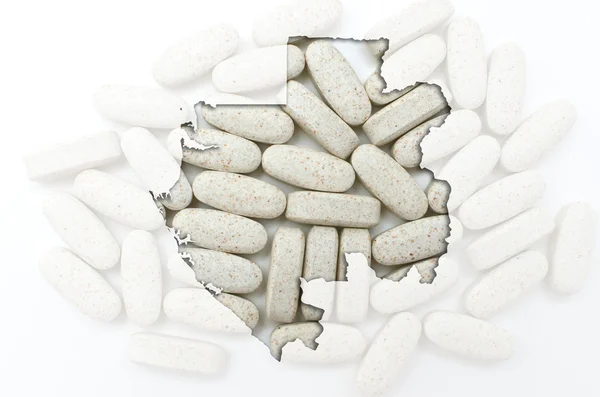 Outline map of gabon with pills in the background for health and — Stock Photo, Image