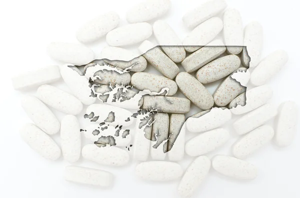 Outline map of guinea bissau with pills in the background for he — Stock Photo, Image