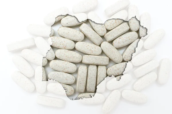 Outline map of nigeria with pills in the background for health a — Stock Photo, Image
