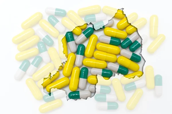 Outline map of rwanda with pills in the background for health an — Stock Photo, Image