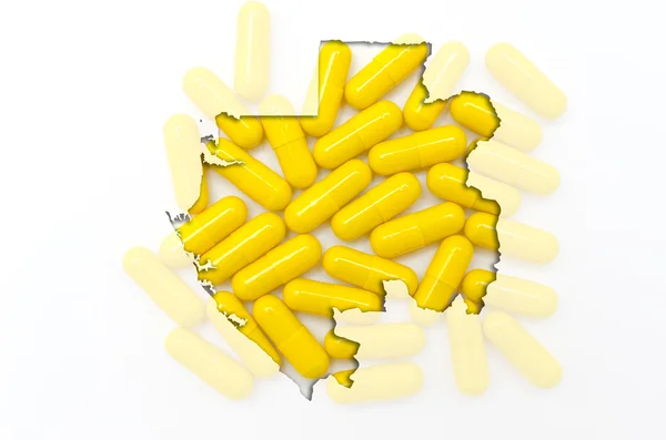Outline map of gabon with pills in the background for health and — Stock Photo, Image