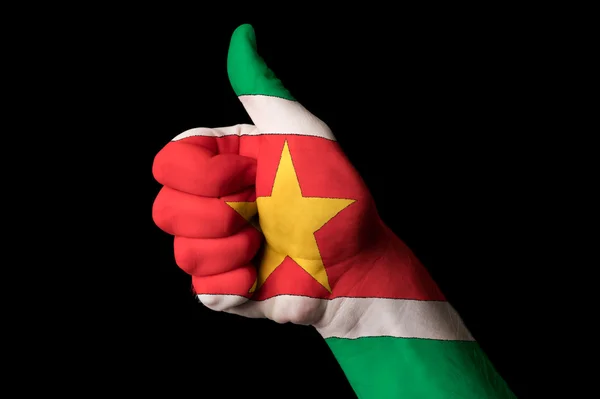 Surinam national flag thumb up gesture for excellence and achiev — Stock Photo, Image