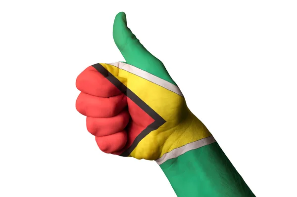Гайянський Національний прапор великий палець вгору жестом за видатні досягнення і досягнення — стокове фото