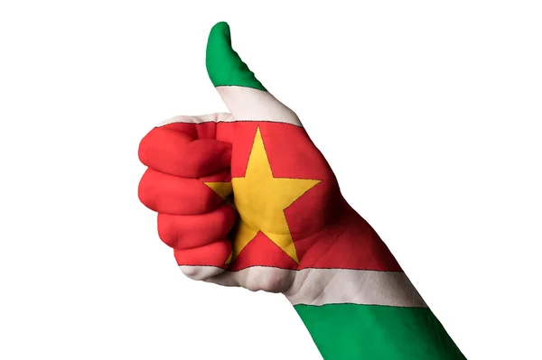 Surinam national flag thumb up gesture for excellence and achiev — Stock Photo, Image