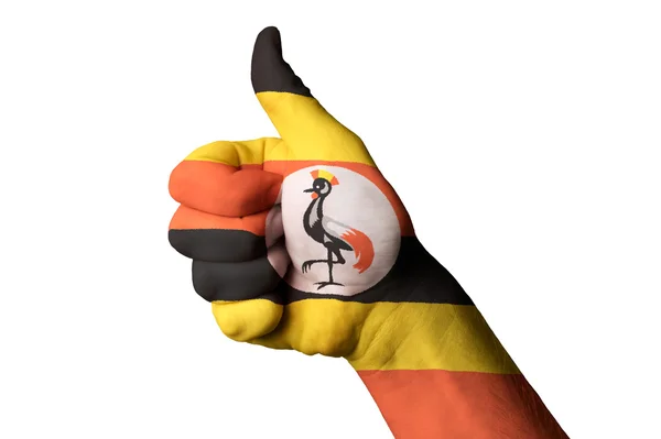 Uganda zászlaja hüvelykujját, gesztus, a kiválóság, és elérése — Stock Fotó
