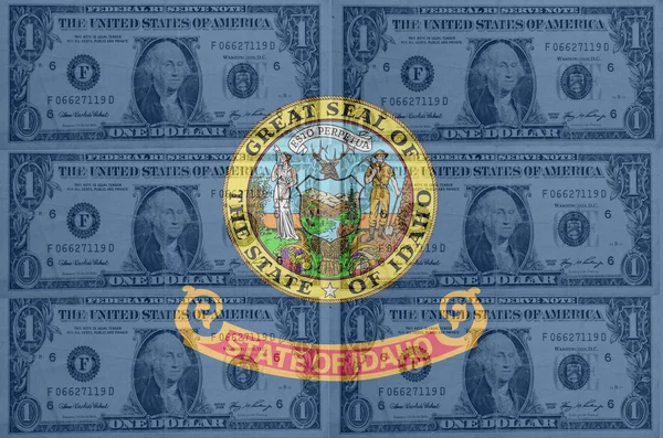 US state of idaho flag with transparent dollar banknotes in back — Stock Photo, Image