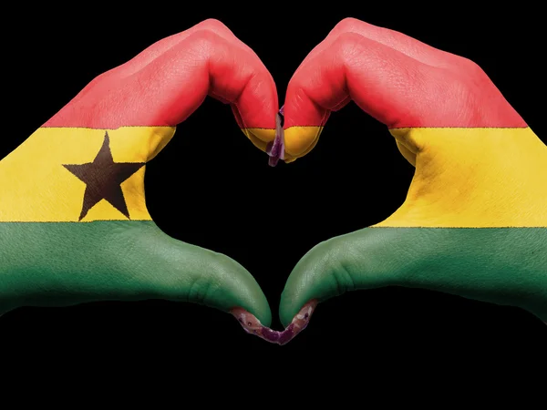 Heart and love gesture by hands colored in ghana flag for touris — Stock Photo, Image