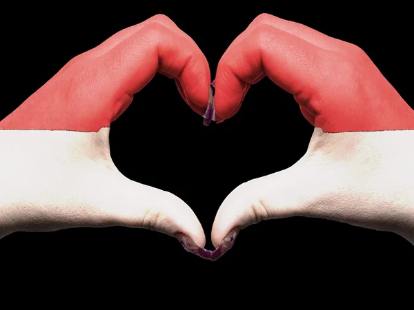 Heart and love gesture by hands colored in indonesia flag for to — Stock Photo, Image