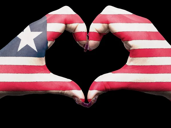 Coração e gesto de amor por mãos coloridas na bandeira da Libéria para turnê — Fotografia de Stock