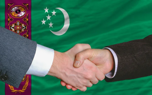 Businessmen handshake after good deal in front of turkmenistan f — Stock Photo, Image