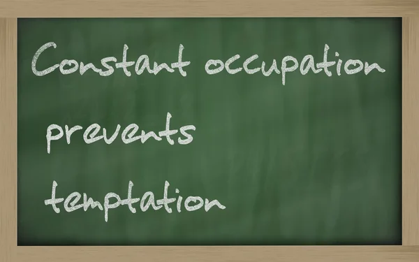 " Constant occupation prevents temptation " written on a blackbo — Stock Photo, Image
