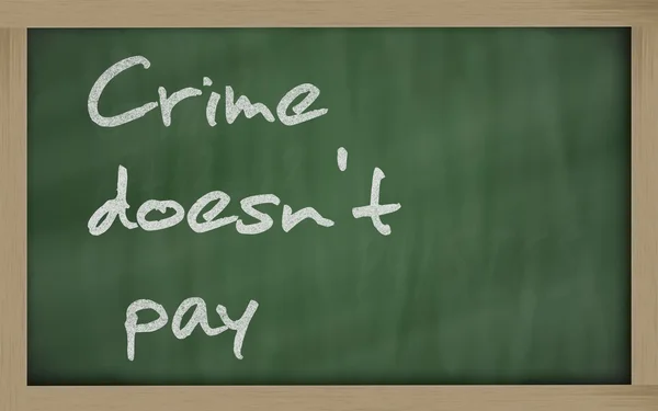 " Crime doesn't pay " written on a blackboard — Stock Photo, Image
