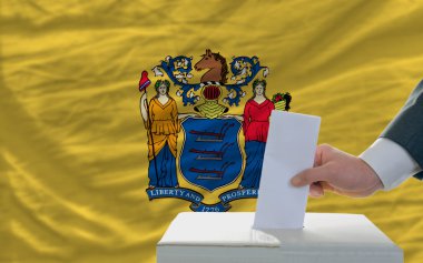 Man voting on elections in front of flag US state flag of new je clipart