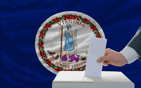 Homem votando nas eleições em frente à bandeira do Estado dos EUA Bandeira da virgem — Fotografia de Stock