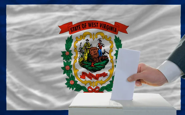 Man röstar om valet framför flagga oss statligt flagga västra v — Stockfoto