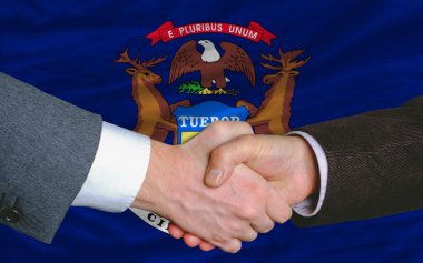 In front of american state flag of michigan two businessmen hand clipart