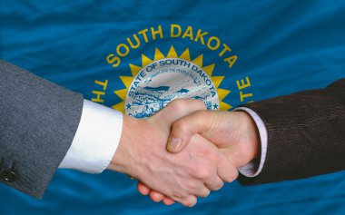 In front of american state flag of south dakota two businessmen clipart