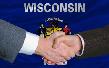 In front of american state flag of west wisconsin two businessme clipart