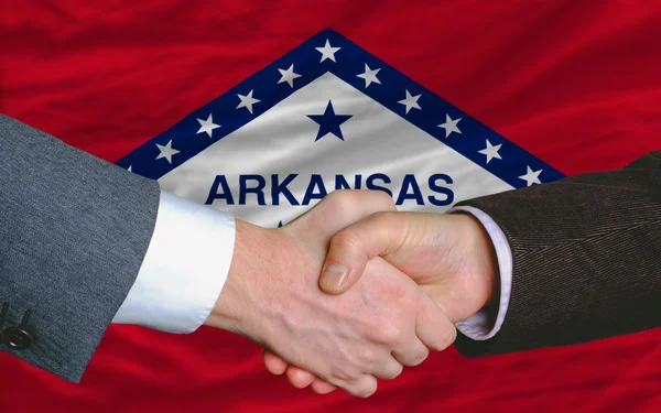 In front of american state flag of arkansas two businessmen hand — Stock Photo, Image