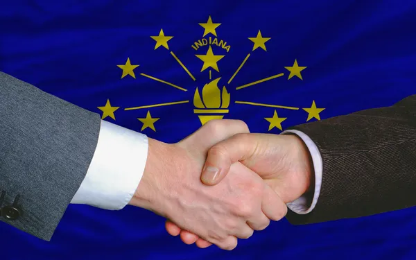 In front of american state flag of indiana two businessmen hands — Stock Photo, Image
