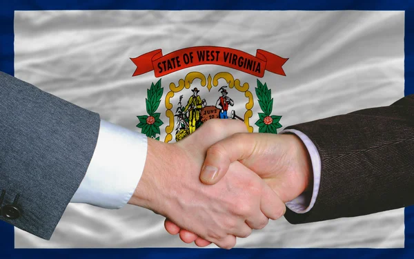 stock image In front of american state flag of west virginia two businessmen