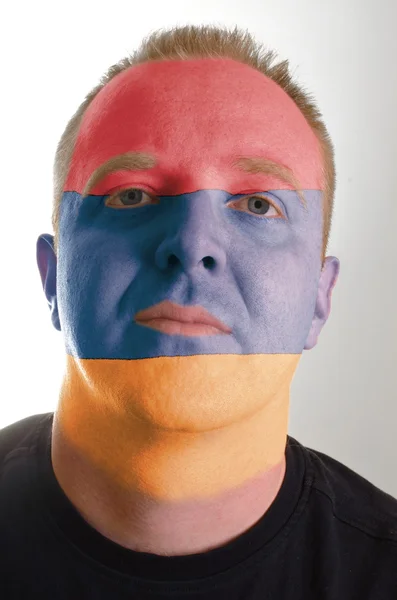 Face of serious patriot man painted in colors of armenia flag — Stock Photo, Image