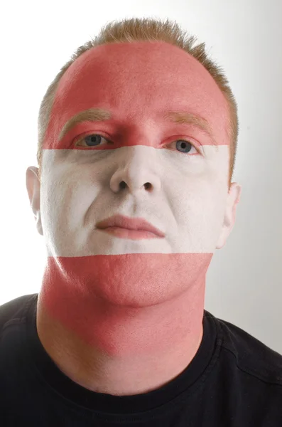 Face of serious patriot man painted in colors of austria flag — Stock Photo, Image