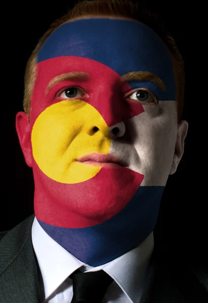 Us state of colorado flag painted face of businessman or politic — Stock Photo, Image