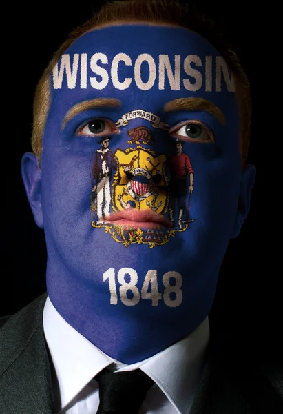 Us state of wisconsin flag painted face of businessman or politi — Stock Photo, Image