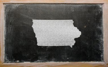 Outline map of us state of iowa on blackboard clipart