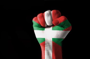 Fist painted in colors of basque flag clipart