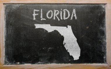 Outline map of us state of florida on blackboard clipart