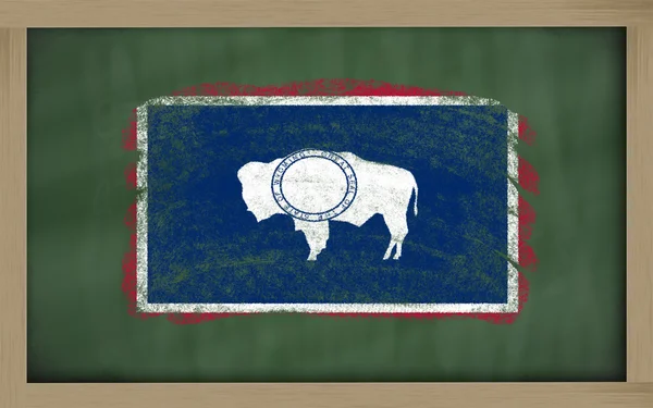 Flag of us state of wyoming on blackboard painted with chalk — Stock Photo, Image
