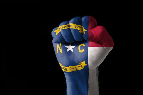 Fist painted in colors of us state of north carolina flag — Stock Photo, Image