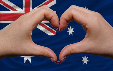 Over national flag of australia showed heart and love gesture ma clipart