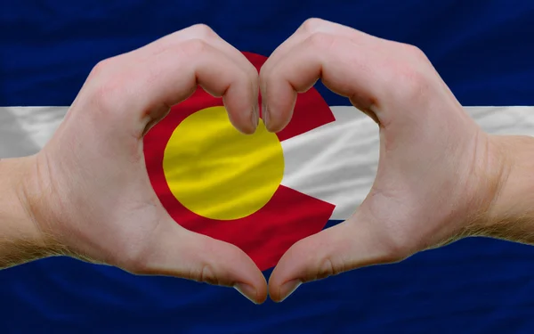 Over american state flag of colorado showed heart and love gestu — Stock Photo, Image