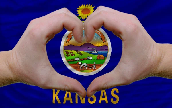 Over american state flag of kansas showed heart and love gesture — Stock Photo, Image