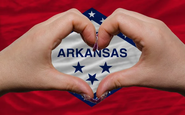 Over american state flag of arkansas showed heart and love gestu — Stock Photo, Image