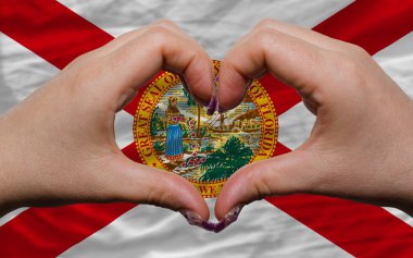 Over american state flag of florida showed heart and love gestur clipart