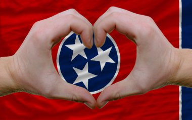 Over american state flag of tennessee showed heart and love gest clipart