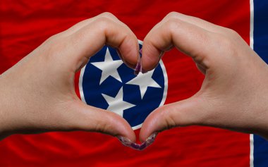 Over american state flag of tennessee showed heart and love gest clipart