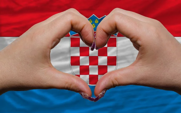 Over national flag of croatia showed heart and love gesture made — Zdjęcie stockowe