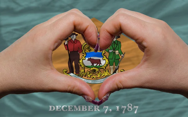 Over american state flag of delaware showed heart and love gestu — Stock Photo, Image