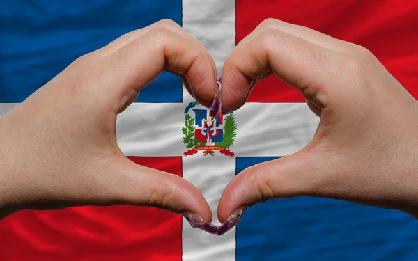 Over national flag of dominican showed heart and love gesture ma — Stock Photo, Image