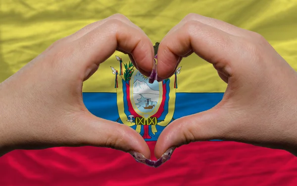 Over national flag of ecuador showed heart and love gesture made — Stock Photo, Image