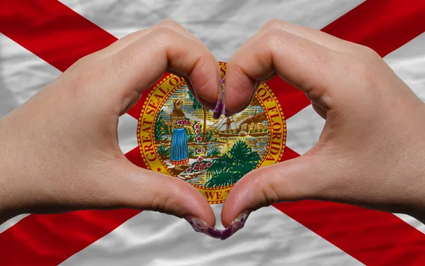 Over american state flag of florida showed heart and love gestur — Stock Photo, Image